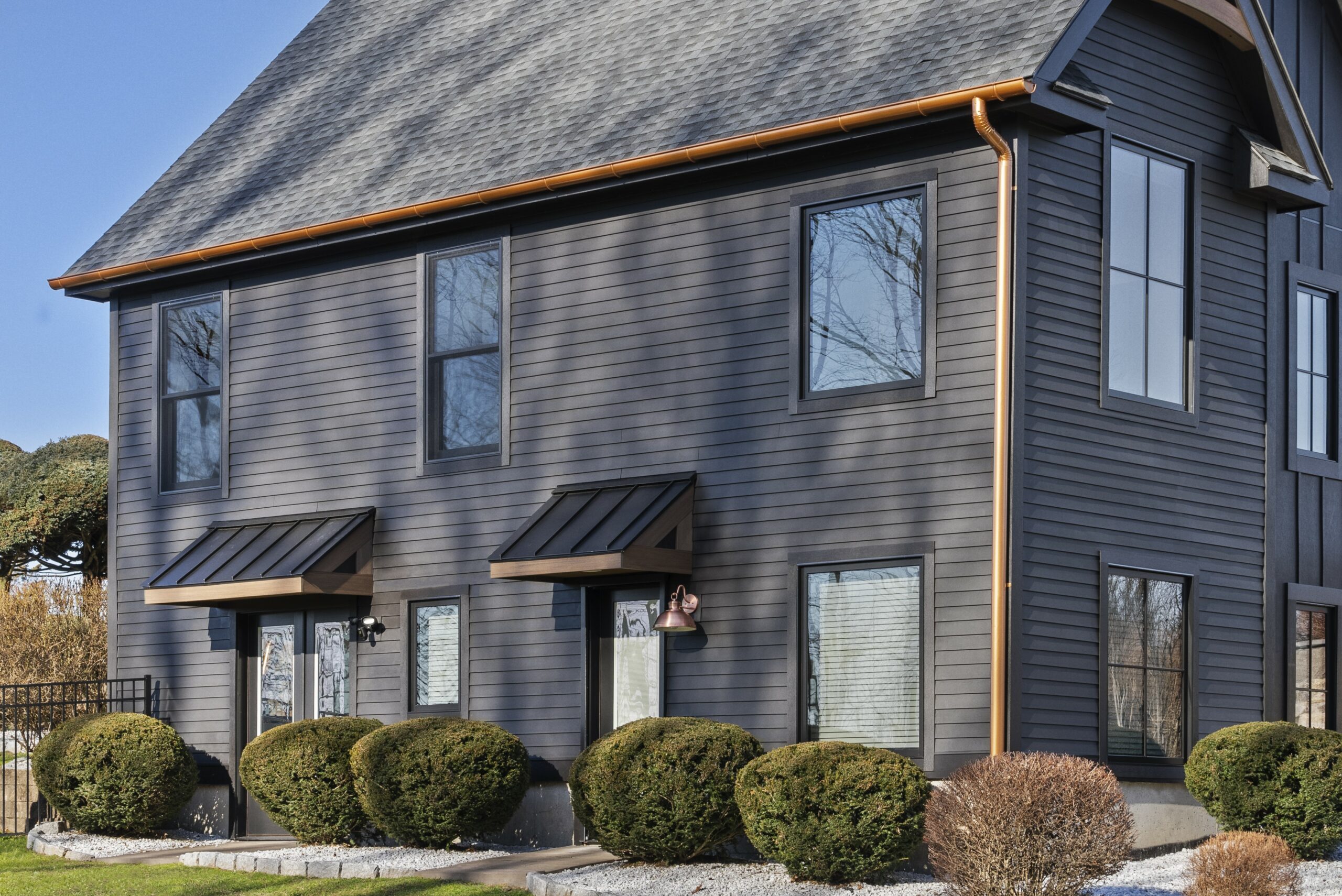 This image depicts a two-story home with a black exterior.