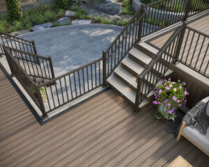 This image depicts a multi-level deck design with black railings. There is a flower pot next to a chair.